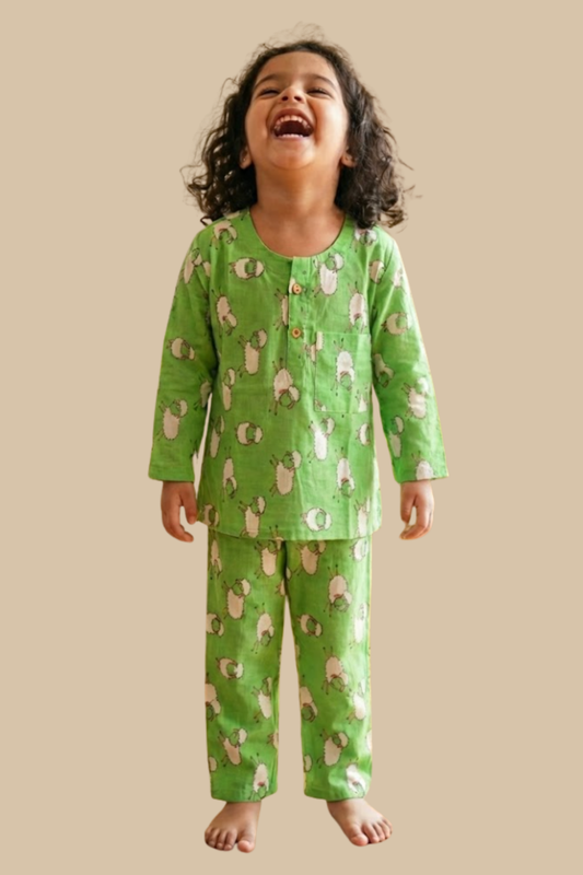 Child wearing green pajamas with animal pattern on a beige background