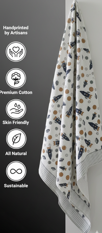 Handprinted towel with astronaut-themed pattern on a gray background